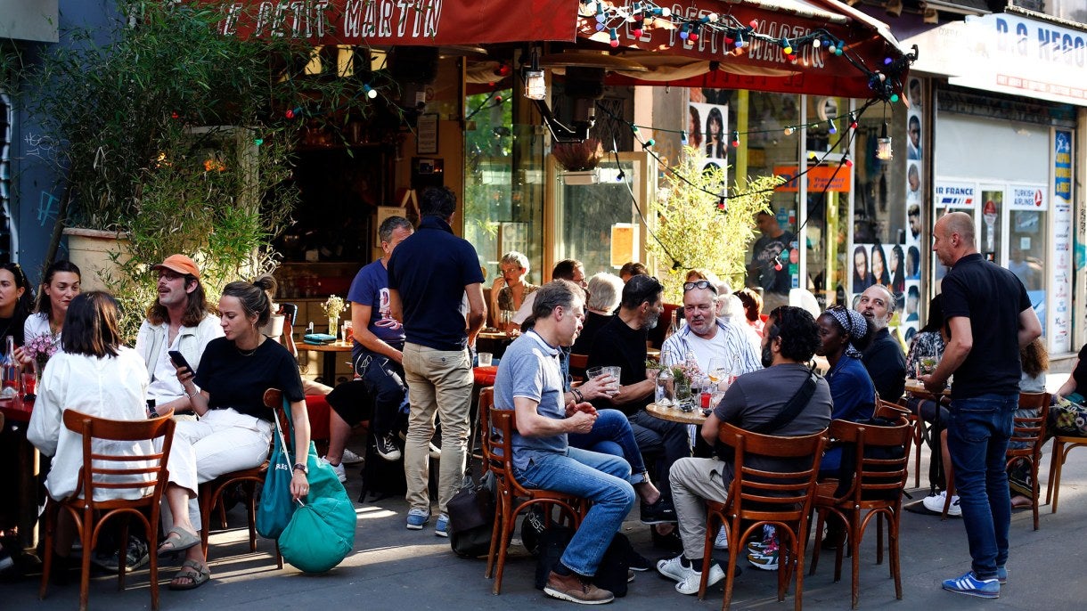 People sit on the terrace of a cafe in Paris