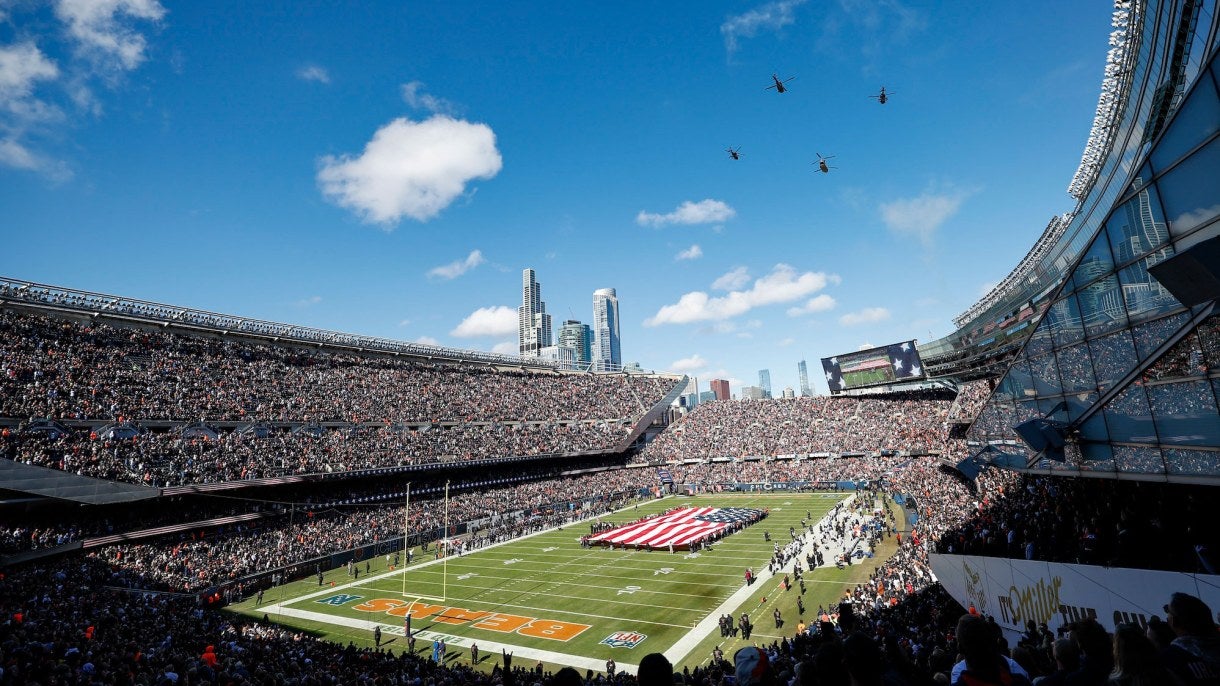 An aerial shot of the inside of Soldier Field, with planes flying overhead