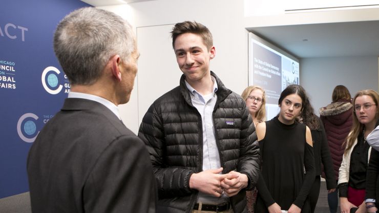 Interns meeting a speaker after a public program