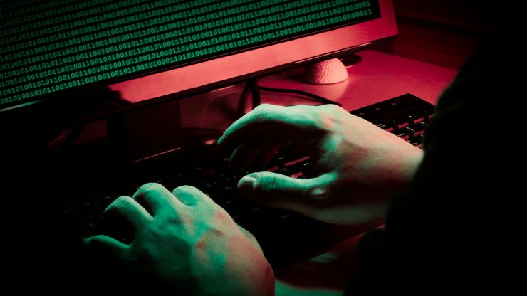 A close-up shot of a person's hands typing on a computer keyboard
