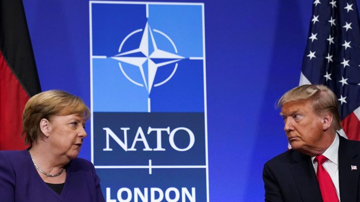 Angela Merkel and Donald Trump face each other at the NATO Summit.