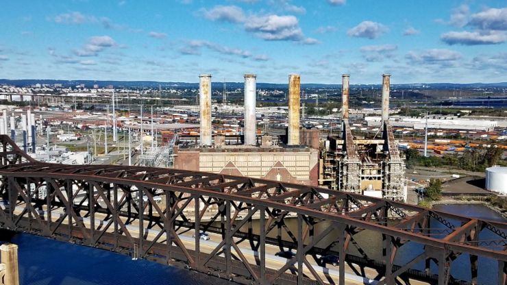 Industrial city skyline and bridge with blue clouds. 