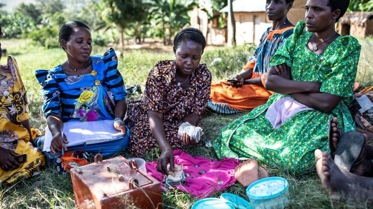 Gorreti Ndagire (center), 40, counts money during a Savings and Internal Lending Communities (SILC) group meeting in Katoosi village, Ddwaniro subcounty, Rakai district, Uganda, January 30, 2019.