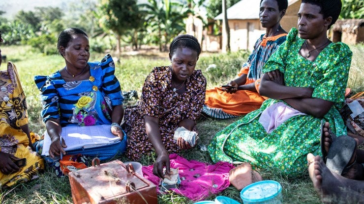 Gorreti Ndagire (center) counts money during a Savings and Internal Lending Communities (SILC) group meeting in Katoosi village, Ddwaniro subcounty, Rakai district, Uganda.