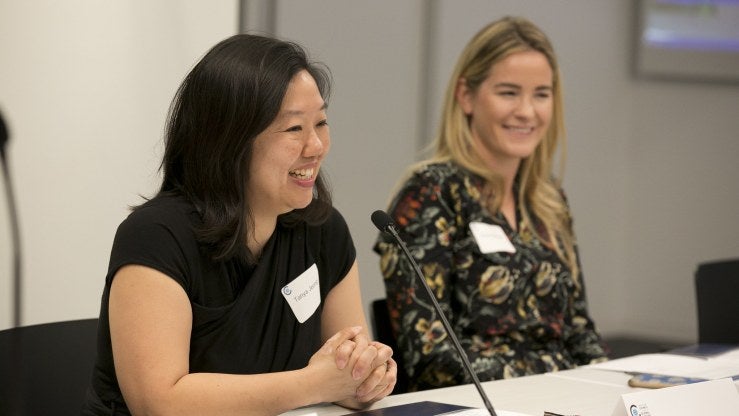 Two people talk and laugh at a table