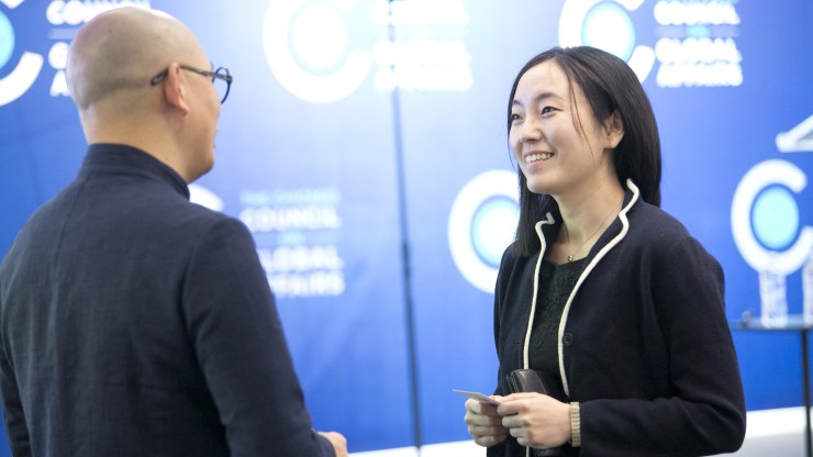 A man and a woman have a conversation at the Chicago Council Conference Center. 