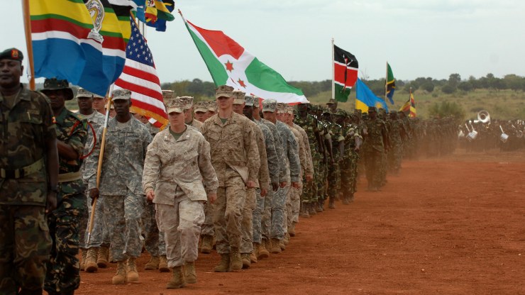 US and African troops march with flags