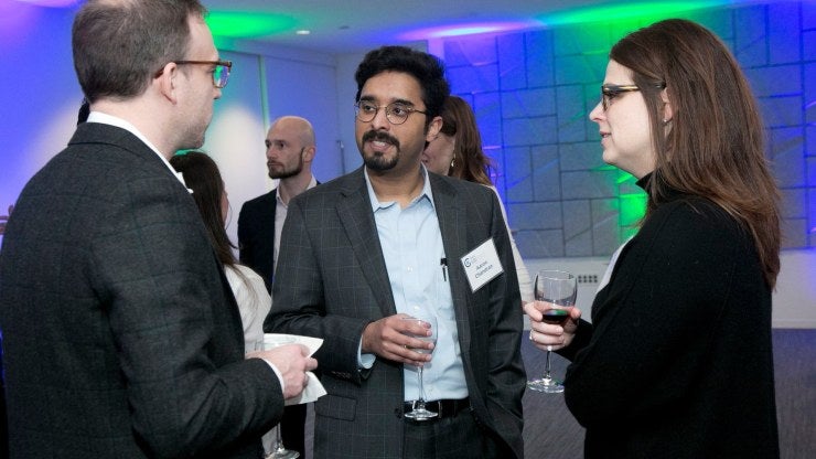 A group of YP Ambassadors talking at an event.