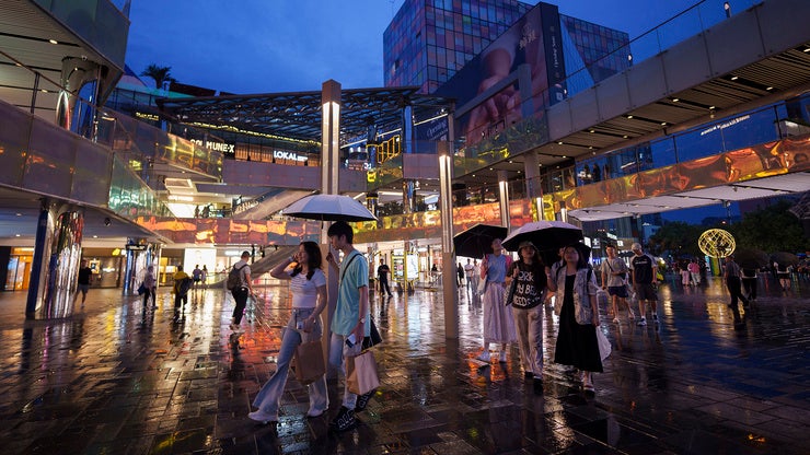People walk in a shopping center in China