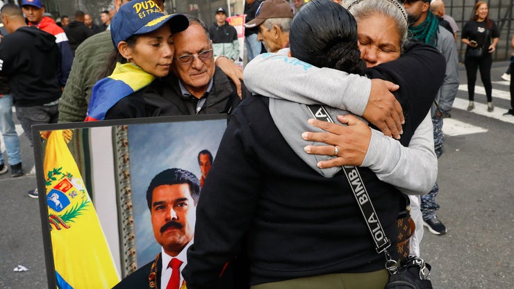 Supporters of Venezuelan President Nicolás Maduro embrace in downtown Caracas, Venezuela, Saturday, Jan. 3, 2026, after U.S. President Donald Trump announced that Maduro had been captured and flown out of the country. 