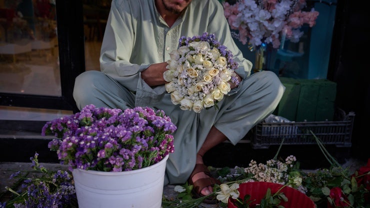 a person holds a bouquet of flowers