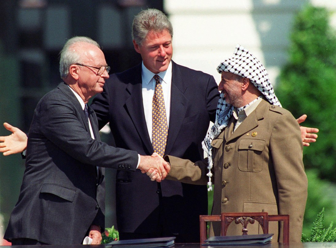  Israeli Prime Minister Yitzhak Rabin, left, and Palestinian leader Yasser Arafat shake hands marking the signing of the peace accord between Israel and the Palestinians, in Washington, Sept. 13, 1993