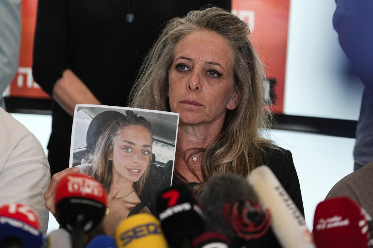 Mother holds photo of daughter kidnapped by Hamas