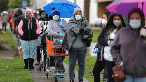 People queue to pick up fresh food at a Los Angeles Regional Food Bank, as the spread of the coronavirus disease (COVID-19) continues