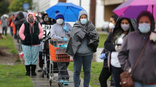 People queue to pick up fresh food at a Los Angeles Regional Food Bank, as the spread of the coronavirus disease (COVID-19) continues
