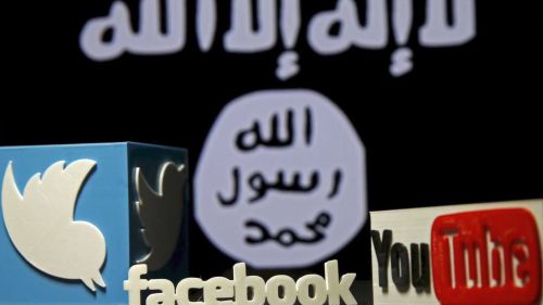 The Twitter, Facebook, and YouTube logos sit in front of the ISIS flag