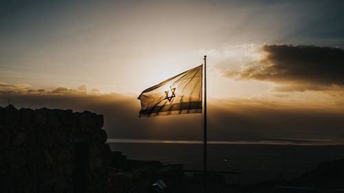 Israeli flag with landscape in the background 