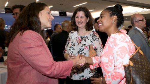 Members of the President's Club talk to Council staff member, Rachael Mizuno.