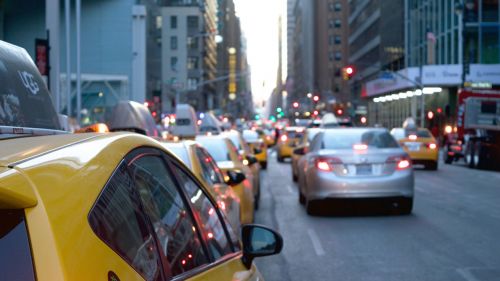Traffic on a city street, with yellow taxi cabs