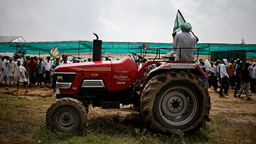 An Indian farmer sits on his tractor at a demonstration.