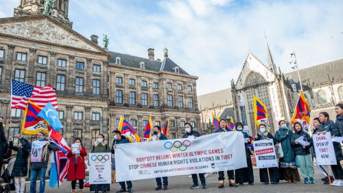 The Tibetan community in The Netherlands holding banners in a square to protest against the celebration of the Olympic Games in Beijing.