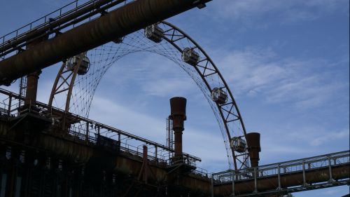 Industrial works silhouetted with a Ferris Wheel in Ruhr, Essen, Germany.