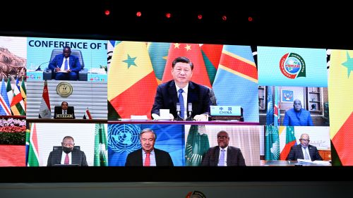 world leaders appear on screen at the Forum on China-Africa Cooperation
