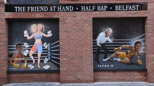 Paintings on a brick wall