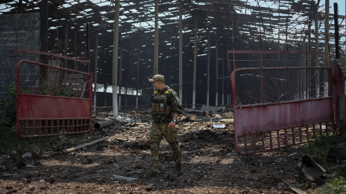 A Ukrainian serviceman walks in a destroyed grain silos after a morning shelling, amid Russia's invasion of Ukraine, near the town of Soledar, Donetsk region Ukraine June 8, 2022.