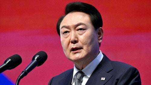 South Korean President Yoon Suk-yeol speaks at a microphone