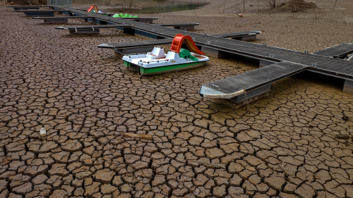 A pedal boat is tied to a dock in a dried part of the Sau reservoir, about 62 miles north of Barcelona, Spain.