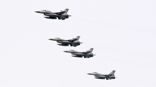 Taiwanese F-16 jet fighters fly in close formation during a navy exercise