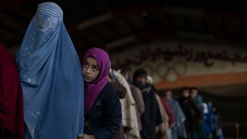 Women queue to receive cash at a money distribution site organized by the World Food Programme (WFP) in Kabul, Afghanistan.