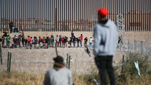 People look at the US-Mexico border wall