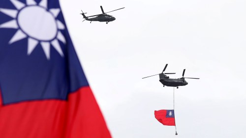 helicopters fly displaying Taiwan's flag