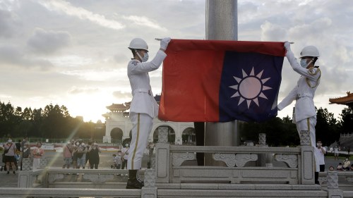 Two soldiers fold the Taiwanese national flag