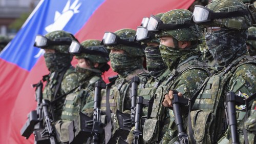 Soldiers pose for group photos with a Taiwanese flag