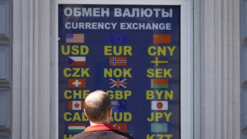 A man stands at a currency exchange office in St. Petersburg, Russia