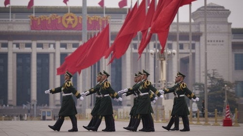 Chinese soldiers march to their post outside the Great Hall of the People in Beijing