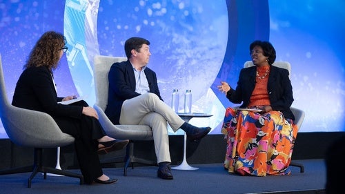 Rebecca Wolfe, Cameron Hudson, and Ertharin Cousin on stage at the Council.