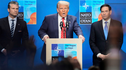 President Donald Trump speaks standing between Secretary of State Marco Rubio, right, and Defense Secretary Pete Hegseth during a press conference at the NATO Summit on June 25, 2025.