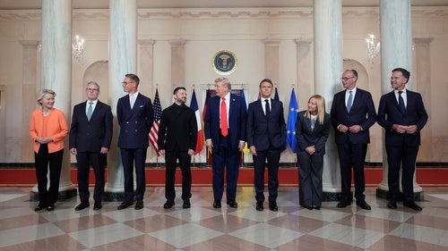 President Donald Trump stands in the middle of a line of European leaders for a photo at the White House on August 18, 2025.