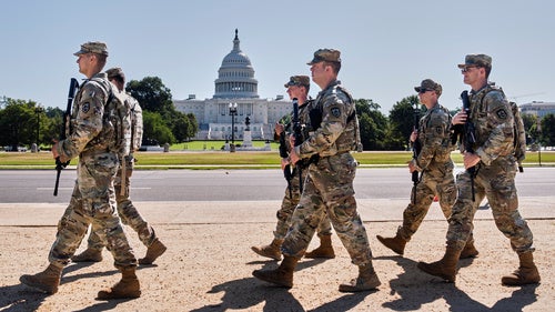 Armed National Guard soldiers from West Virginia patrol the Mall near the Capitol in Washington, DC