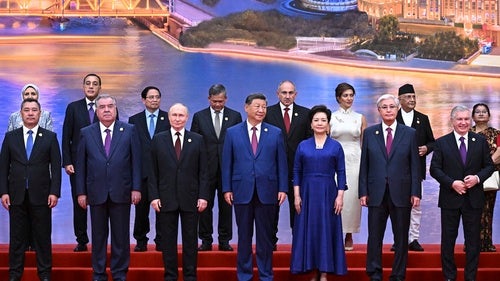 Chinese President Xi Jinping (center) stands among other global leaders at Shanghai Cooperation Organization summit in Tianjin, China, on August 31, 2025.