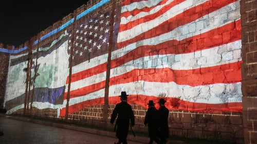 n Image of the US and Israeli flags is projected on the walls of Jerusalem's Old City