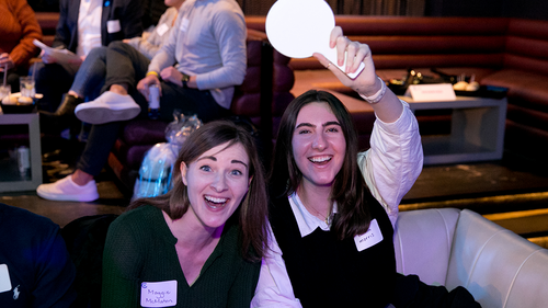 Two trivia bowl attendees smile for a photo.