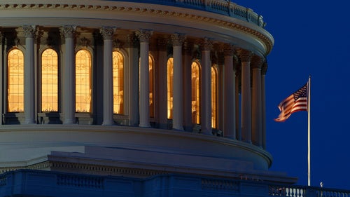 Capital dome at night with American flag