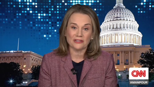 Julianne Smith speaks in front of a background depicting the US Capitol building
