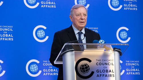 Senator Dick Durbin speaking at the podium during a press briefing at the Chicago Council on Global Affairs.