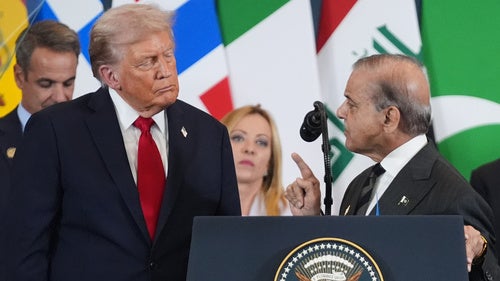 President Donald Trump listens as Pakistan's Prime Minister Shehbaz Sharif speaks at a podium